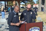 End of Watch Ride to Remember spokesperson Jagrat Shah confers with Lemoore Police Chief Michael Kendall during Saturday's tribute to Officer Jonathan Diaz in Veterans Park during which a Harley-Davidson motorcycle was donated.